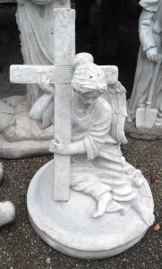 concrete angel holding cross on base christian statue tallahassee florida garden summer